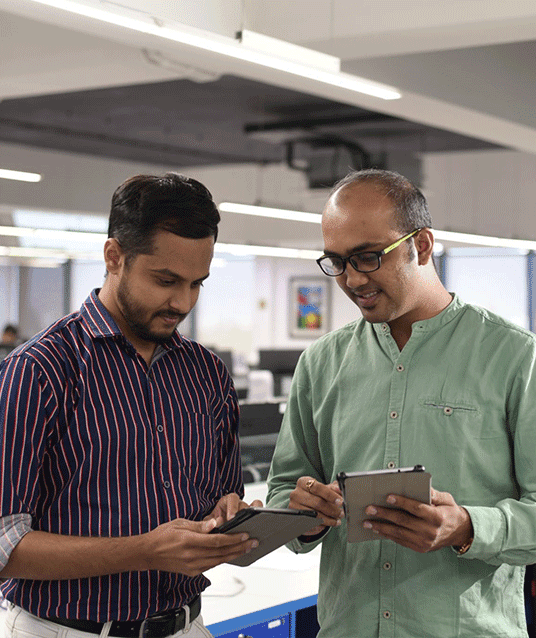PMC employee using tablet device and discussing